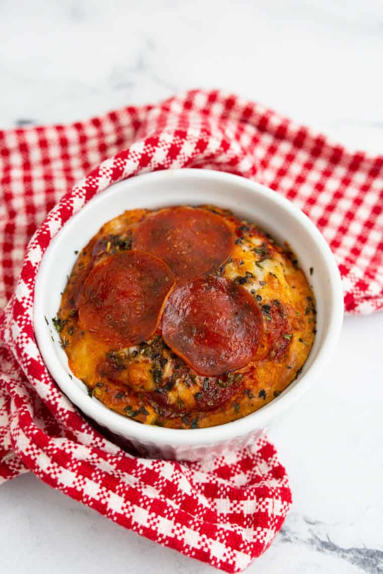 Air fryer mug pizza in a mug with melted cheese, sauce, and toppings