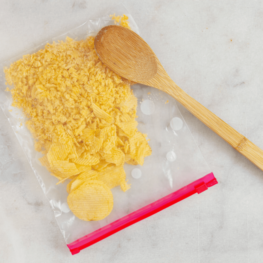 Crushing potato chips in a food processor or Ziploc bag with a rolling pin until fine