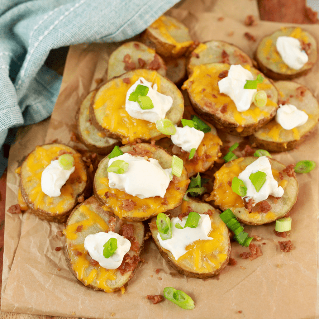 "Delicious Air Fryer Loaded Potato Rounds topped with cheese, bacon, and green onions."