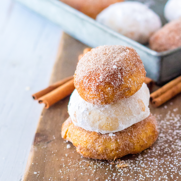 Air fryer pumpkin cheesecake donut holes served on a fall table with coffee