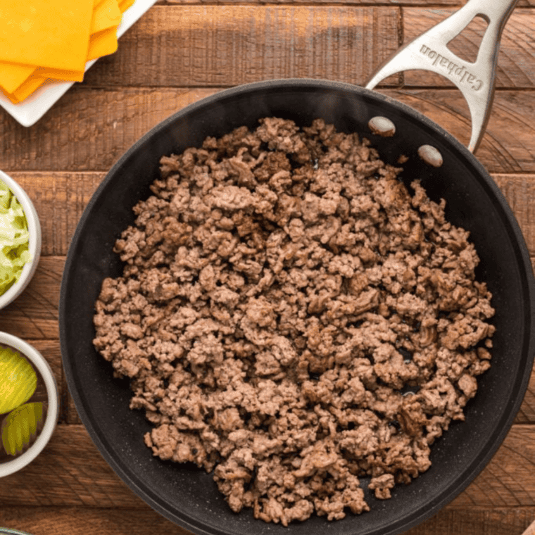 Cooked ground beef mixed with ketchup, mayo, and mustard in a bowl, ready for use in Air Fryer Taco Burgers.