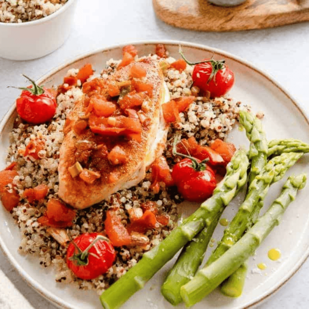 Air fryer Tuscan chicken with creamy sun-dried tomato sauce and fresh herbs served on a plate.