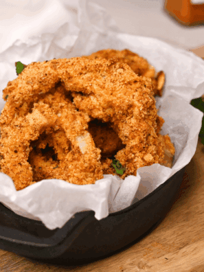 Crispy golden copycat Culver’s onion rings stacked on a plate, ready to serve