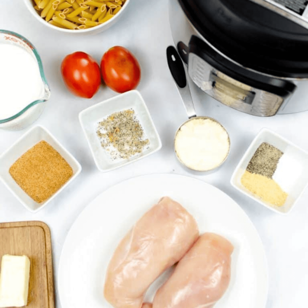 Ingredients needed for Instant Pot Chilis Copycat Cajun Chicken Pasta on kitchen table.