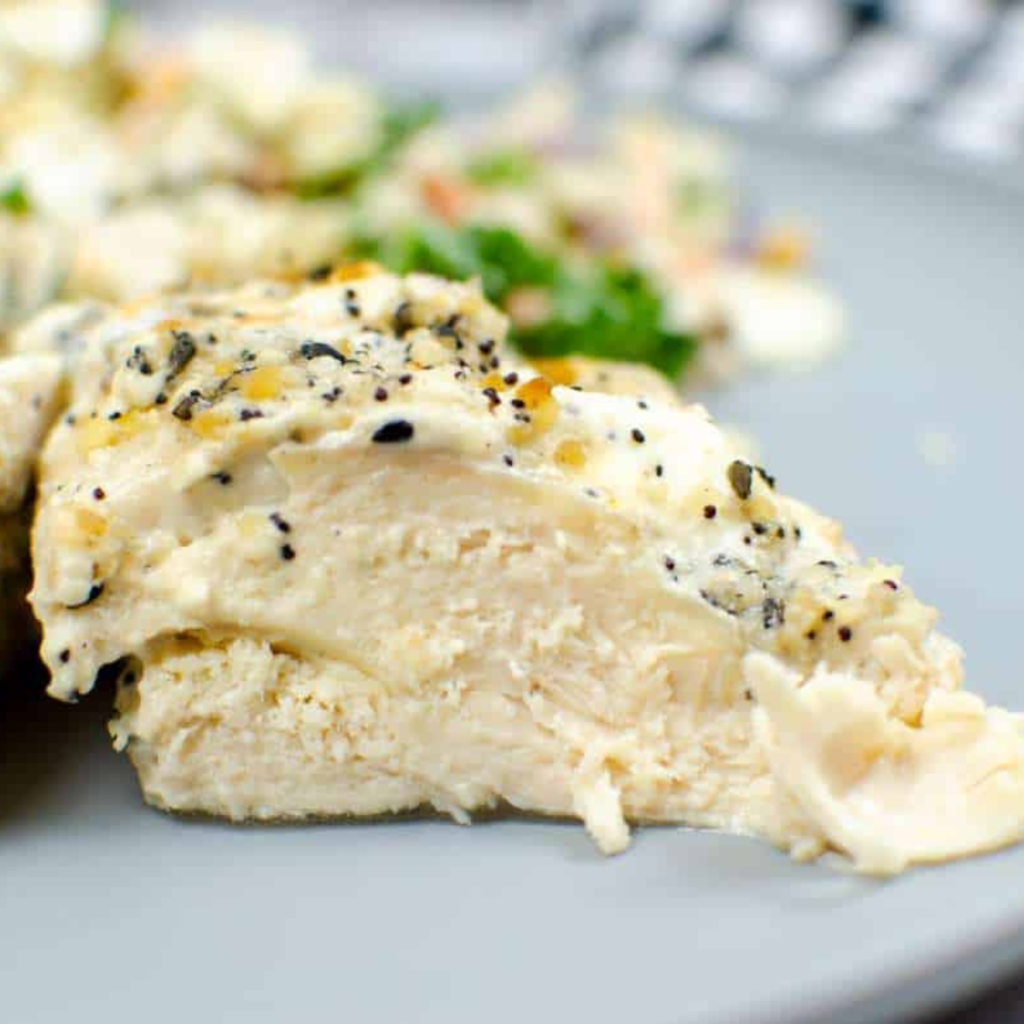 Instant Pot Cream Cheese Chicken served over rice with fresh parsley on top in a white bowl
