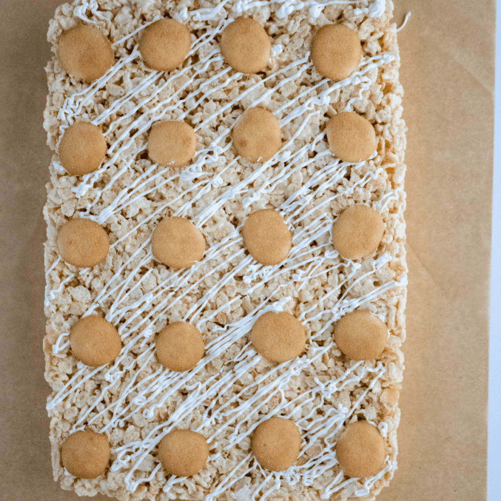 Banana pudding Rice Krispie treats resting in a baking dish to set before serving.