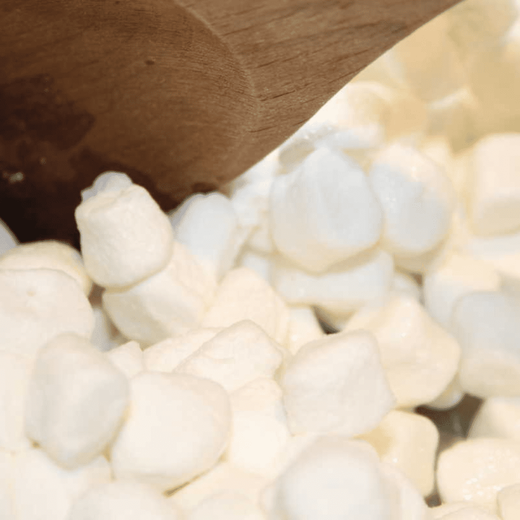 Sautéing butter and melting marshmallows in the Instant Pot, then stirring in rice cereal until fully coated.