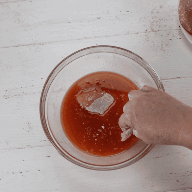 Dip the seasoned chicken into the hot sauce mixture.