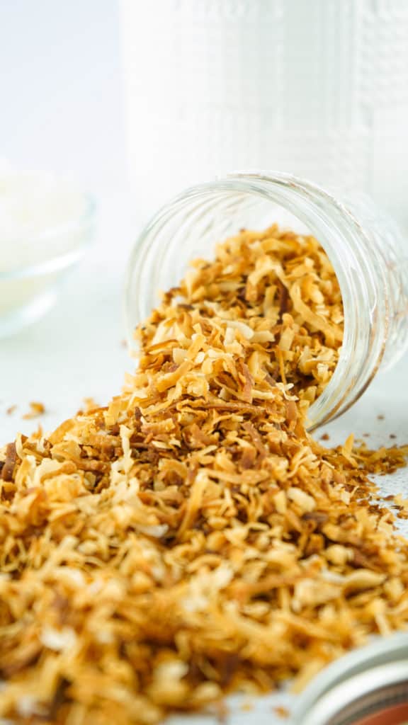 Coconut flakes being stirred in the air fryer