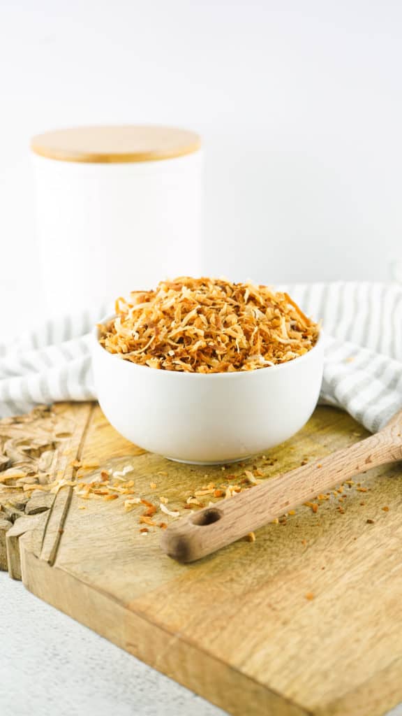 Toasted Coconut in Bowl on table.