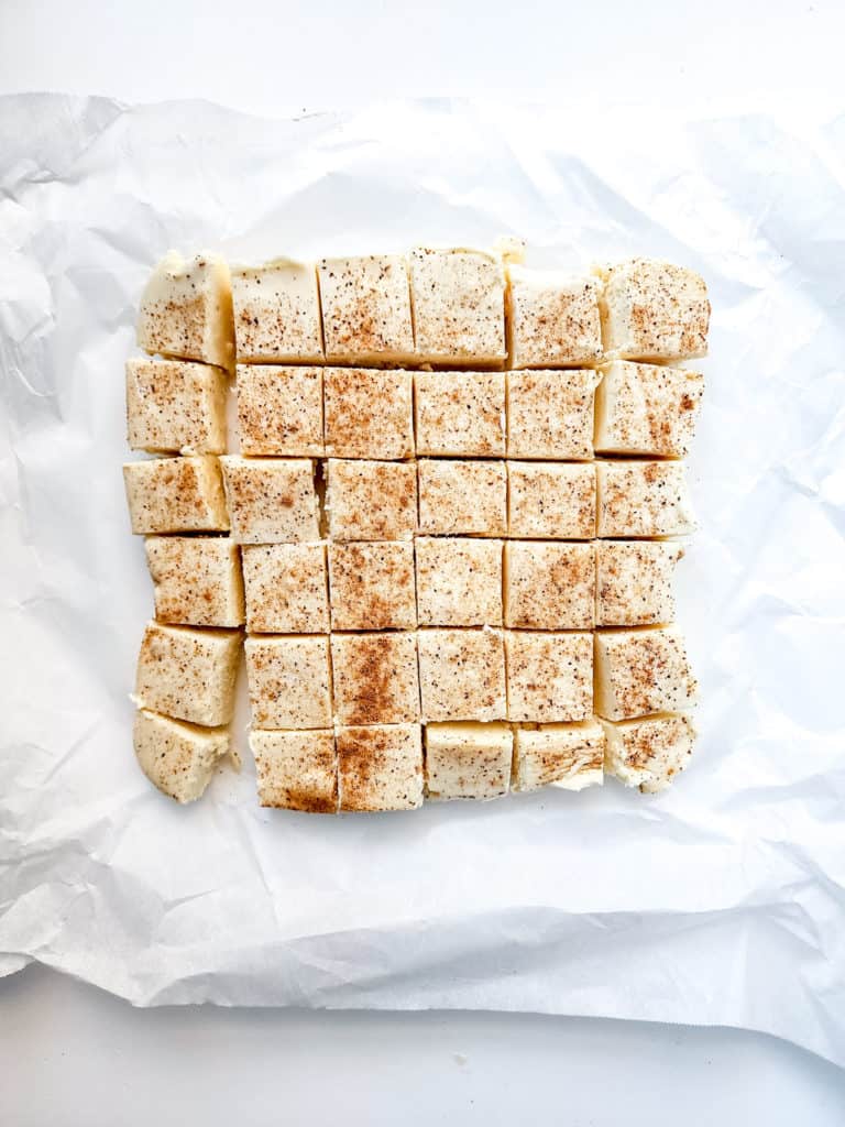 "Removing cooked eggnog fudge from the Instant Pot and placing it onto a cooling rack."