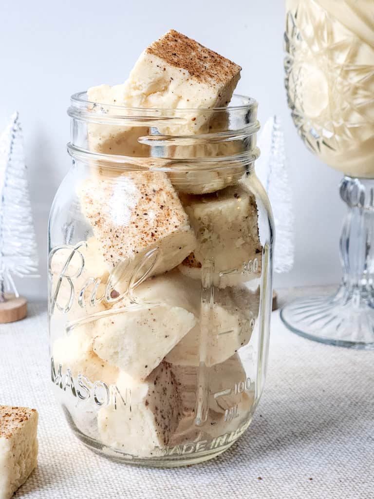 "Close-up of creamy, golden Instant Pot Eggnog Fudge pieces arranged on a decorative plate."
