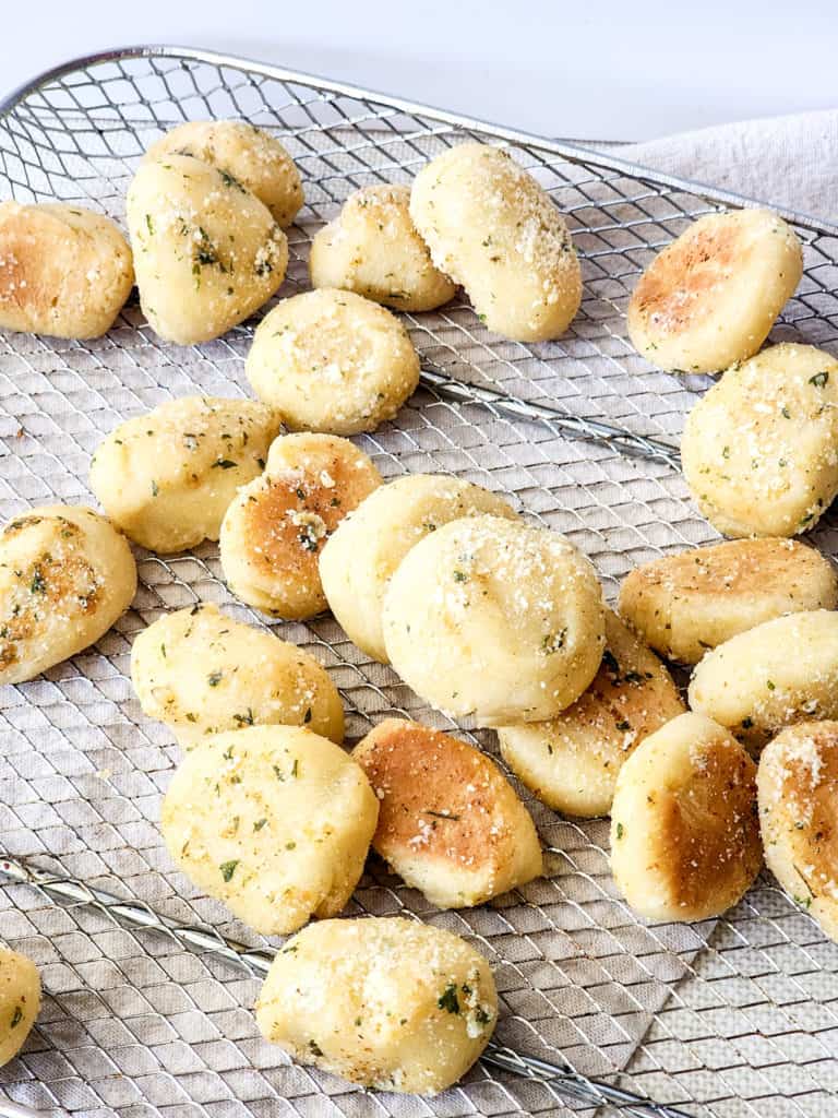 Air Fryer Copycat Domino’s Parmesan Bites being served from the air fryer basket, showcasing their appetizing appearance and crispy texture.