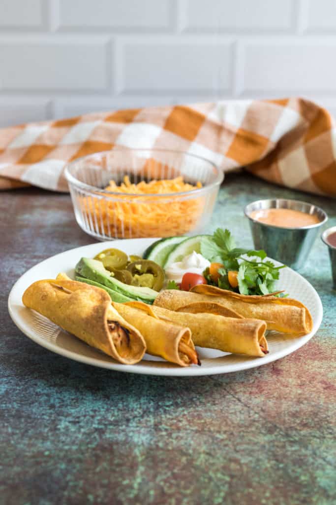 Preheat the air fryer: Just like with other cooking methods, it's important to preheat your air fryer. Preheating helps ensure even cooking and allows the taquitos to crisp up properly. Preheat your air fryer to 400°F (200°C) for a few minutes before adding the taquitos.
Use corn tortillas: Corn tortillas tend to work better in the air fryer compared to flour tortillas. Corn tortillas become crispy and hold their shape nicely when air-fried. If using flour tortillas, you may need to lightly spray or brush them with oil to achieve a crispy texture.
Roll tightly and secure with toothpicks: Roll the taquitos tightly to prevent them from unraveling during cooking. To secure the taquitos, you can use toothpicks placed through the seam side. Just remember to remove the toothpicks before serving.
Lightly spray or brush with oil: To enhance the crispiness of the taquitos, you can lightly spray or brush them with oil before air frying. This step is especially helpful if you're using flour tortillas. Use a light coating of cooking spray or brush the taquitos with a small amount of oil.
Don't overcrowd the air fryer basket: Give the taquitos enough space in the air fryer basket to allow proper air circulation. Overcrowding the basket can result in uneven cooking. If needed, cook the taquitos in multiple batches.
Flip halfway through cooking: For even browning and crispiness, flip the taquitos halfway through the cooking time. This ensures both sides are cooked evenly.
Keep an eye on the cooking time: Air fryers can vary in cooking times, so it's important to keep an eye on the taquitos as they cook. Check for a golden, crispy exterior and ensure the filling is heated through. Adjust the cooking time as needed.
Let them rest before serving: After removing the taquitos from the air fryer, let them rest for a few minutes. This allows them to crisp up a bit more and prevents the filling from being too hot when you bite into them.
Serve with dipping sauces: Chicken taquitos are delicious on their own, but you can enhance the flavors by serving them with your favorite dipping sauces. Consider options like salsa, guacamole, sour cream, or a spicy aioli for dipping.