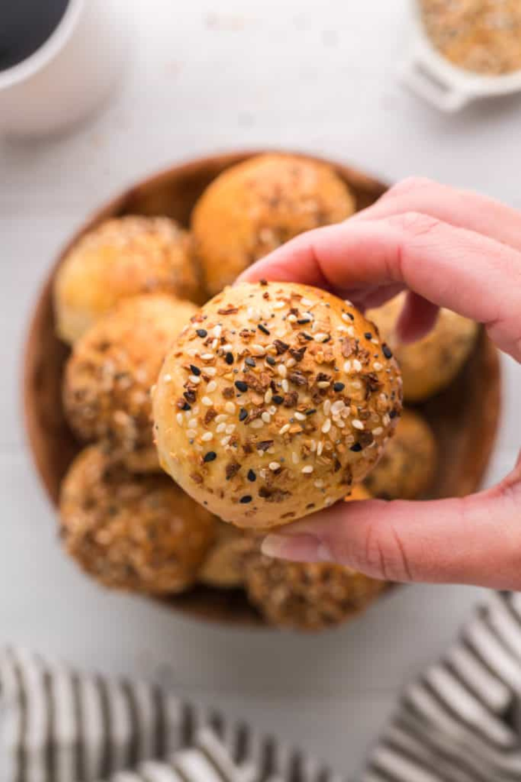 Close-up of homemade 2-ingredient air fryer bagel bites with a crispy golden crust and soft chewy center, fresh from the air fryer basket.