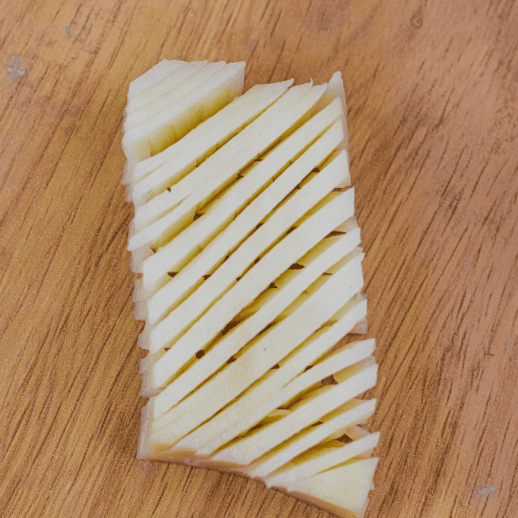 "Step-by-step slicing potatoes to create the accordion effect for air frying."