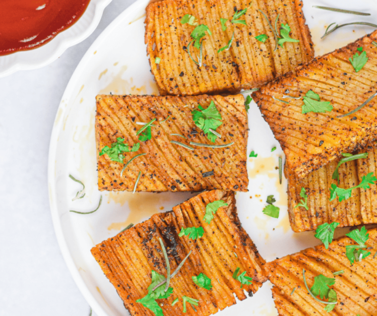 "Crispy air fryer Hasselback potatoes served on a plate."
