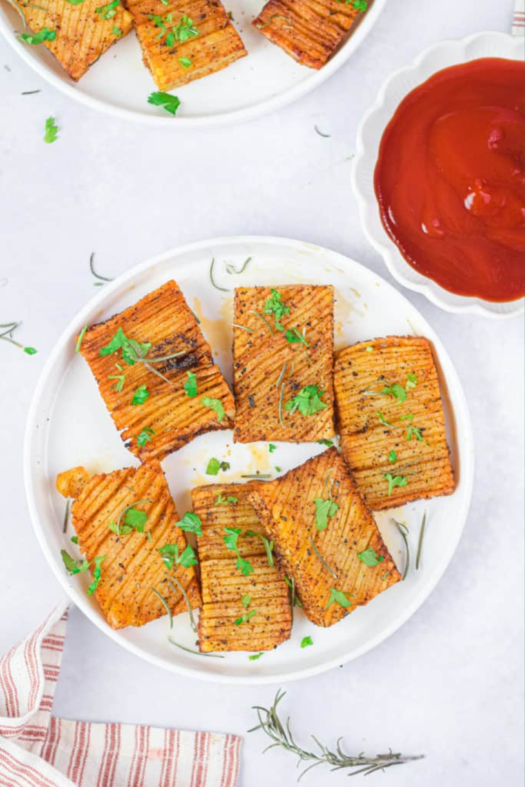 "Golden-brown accordion potatoes fresh from the air fryer, beautifully plated."