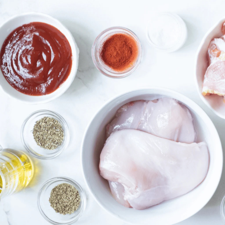 Ingredients for air fryer bacon wrapped chicken tenders including chicken, bacon, and brown sugar rub
