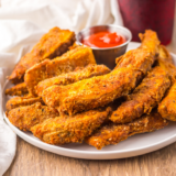 Copycat Buffalo Wild Wings potato wedges tossed in buffalo sauce, served with blue cheese dressing