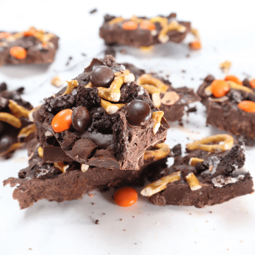 Air fryer chocolate bark melted and spread on parchment paper with toppings ready to set