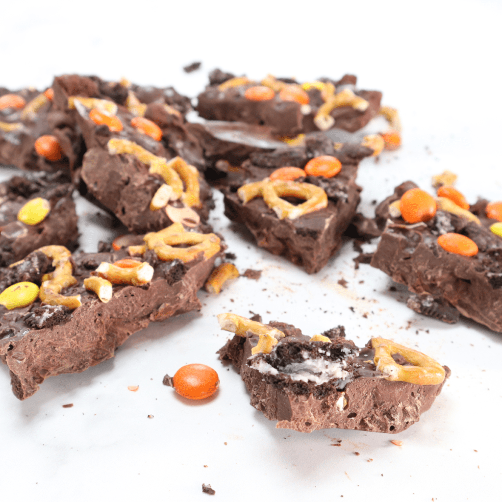 Close-up of flaky sea salt crystals resting on smooth, glossy melted chocolate.