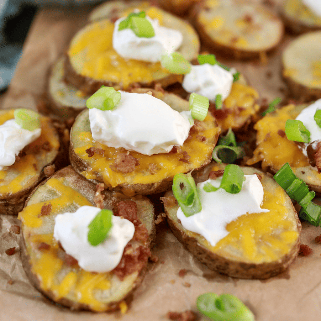 Plate of air fryer cheesy potatoes with toppings.