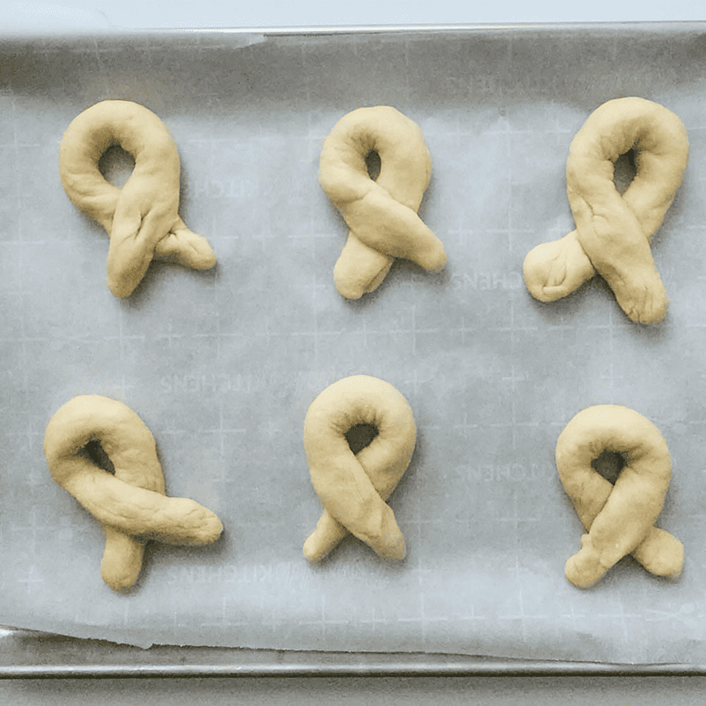 Brushing melted butter onto the rolled-out dough for Air Fryer Cinnamon Bread Twists.