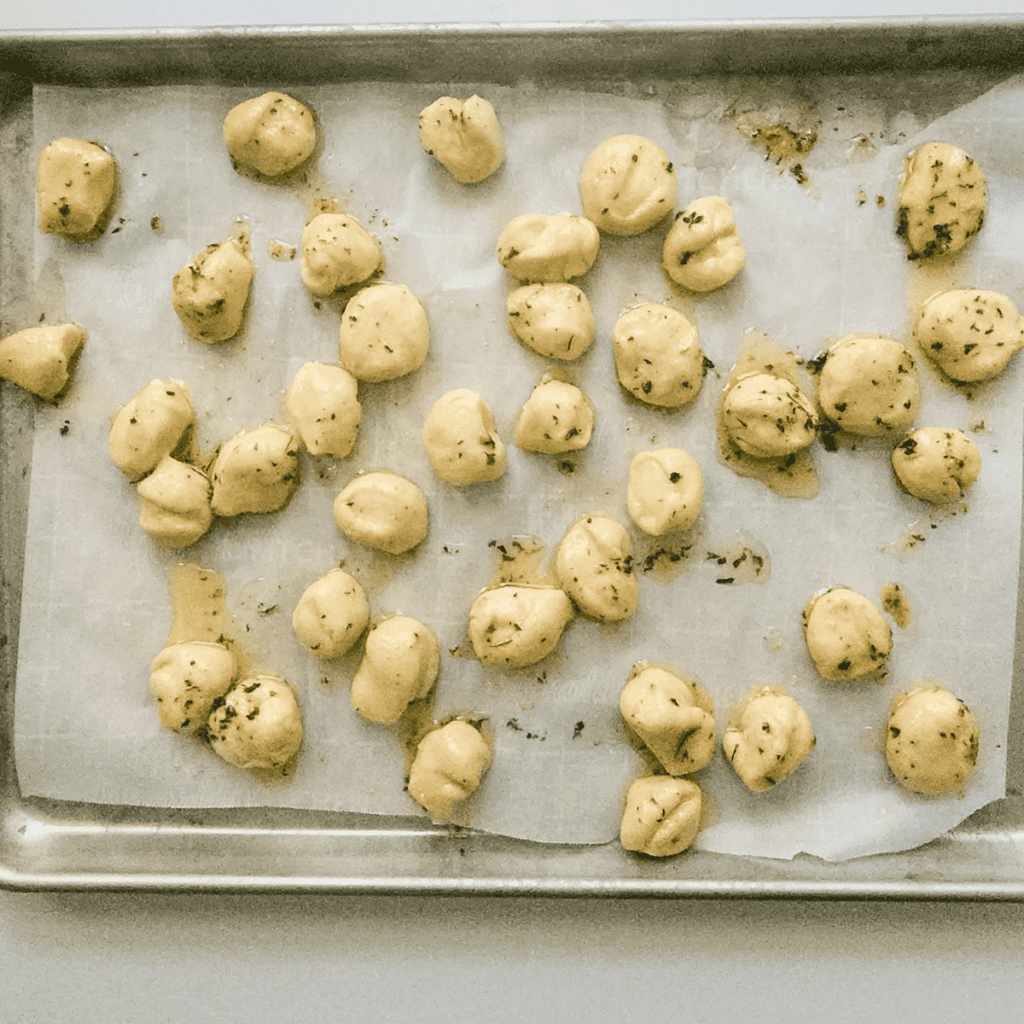 Image of garlic parmesan topping on top of the bread pieces, before air frying.