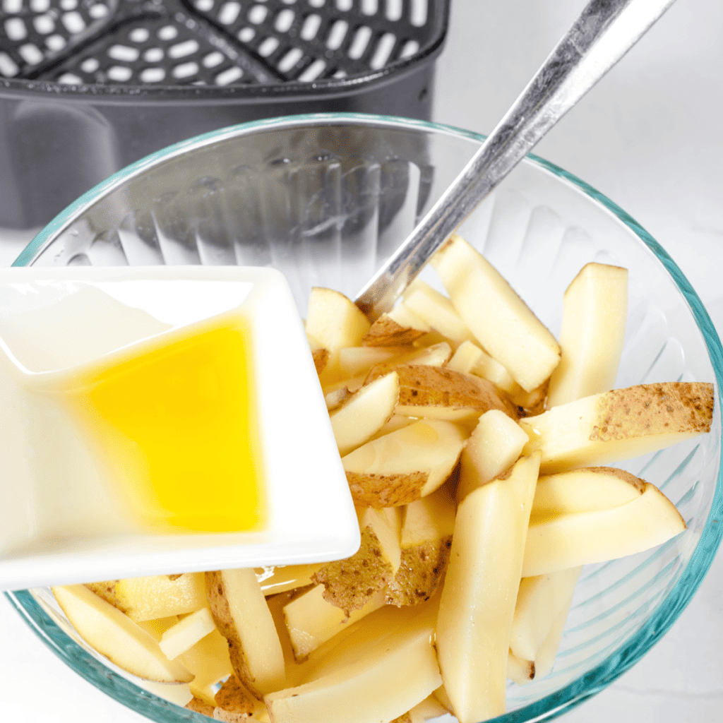 Drizzle cut potatoes with olive oil or cooking spray, toss for even coating.