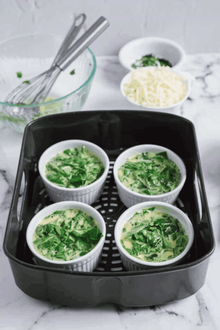 Place uncooked Air Fryer Egg Bites With Cottage Cheese in the air fryer basket.