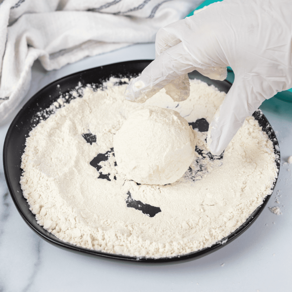 Ingredients laid out for making fried ice cream, including ice cream and batter.