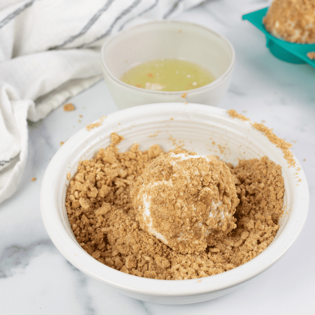 air fryer fried ice cream being coated in cereal.