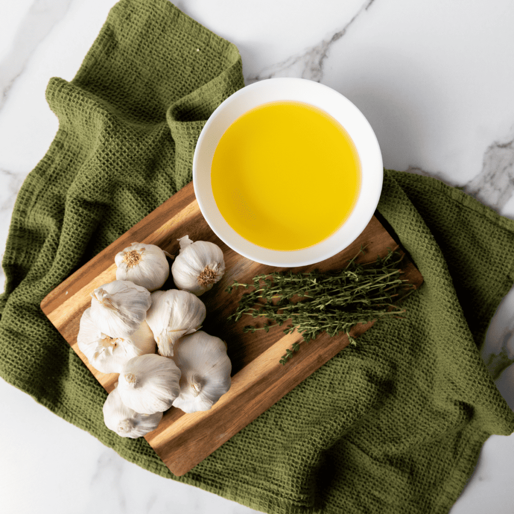 Ingredients Needed For Quick Garlic Confit on kitchen table.