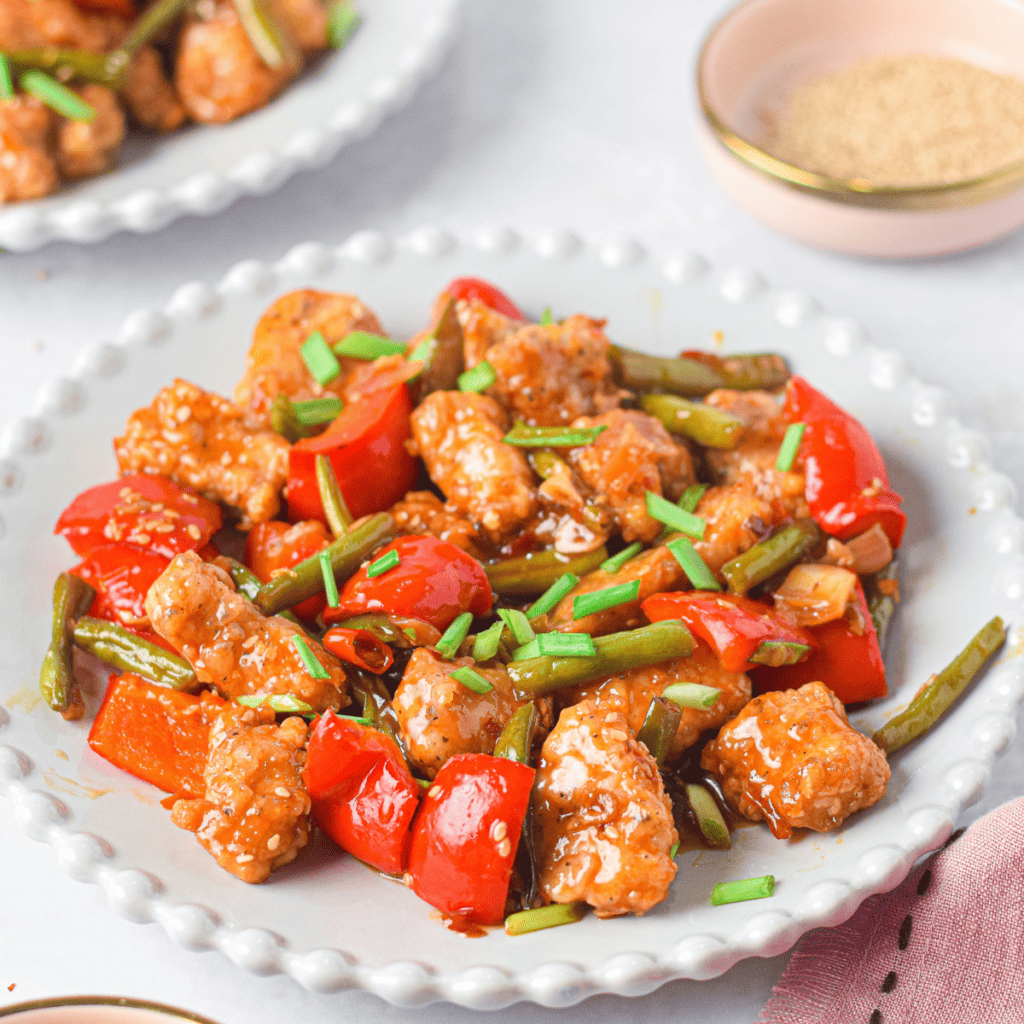 "Crispy air fryer chicken bites coated in a sticky honey garlic sauce."