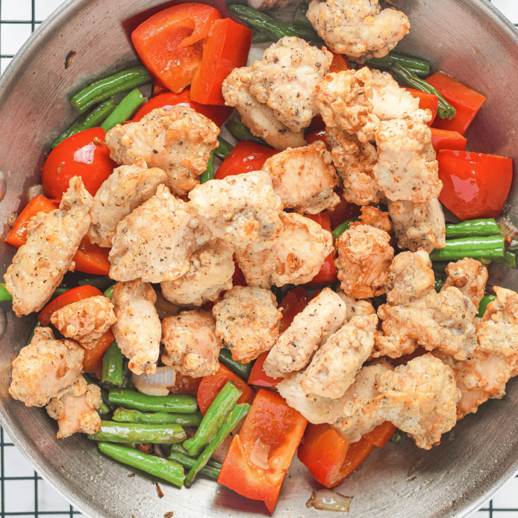 Tossing air-fried chicken bites in a sweet honey garlic sauce."