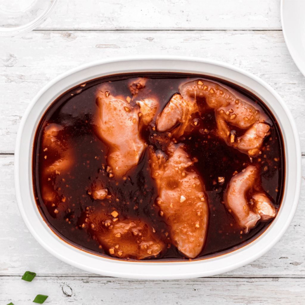 Chicken marinating in a rich Huli Huli sauce for maximum flavor.