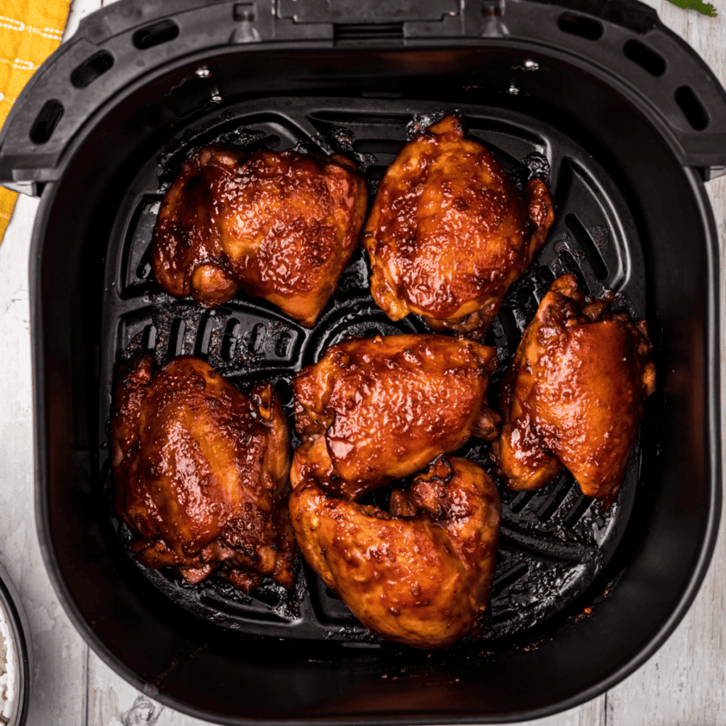 Air Fryer Huli Huli Chicken with a caramelized glaze, served with rice and pineapple.