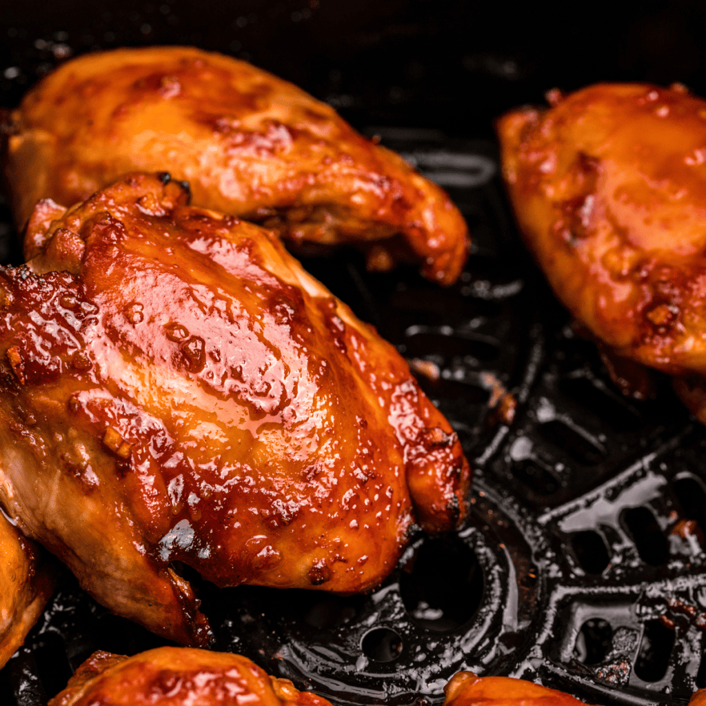 Juicy Air Fryer Huli Huli Chicken glazed with sweet, smoky sauce, served with rice and pineapple slices.
