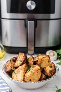 Prep the Potatoes: Wash and scrub the potatoes to remove any dirt or debris. You can peel them if you prefer, but leaving the skin on adds texture and flavor. Cut the potatoes into evenly-sized pieces, typically around 1-inch cubes. 2. Season the Potatoes: In a large bowl, combine the potato cubes with olive oil, salt, black pepper, garlic powder, and paprika. Use your hands or a spoon to toss the potatoes, ensuring they are evenly coated with the seasonings. Feel free to add any optional seasonings or herbs at this stage for extra flavor. 3. Preheat the Instant Pot Air Fryer: Place the Instant Pot Air Fryer Lid on your Instant Pot and preheat it according to the manufacturer's instructions. This usually involves selecting the air fryer function and setting the temperature. 4. Arrange the Potatoes: Spread the seasoned potato cubes in a single layer in the air fryer basket. Avoid overcrowding, as this can hinder proper crisping. If needed, cook them in batches. 5. Air Fry the Potatoes: Set the Instant Pot to air fry mode at a temperature of around 380-400°F (190-200°C). Cook the potatoes for about 20-25 minutes, flipping them halfway through to ensure even browning. Cooking times may vary based on your specific appliance and the size of the potato cubes. 6. Check for Doneness: The roasted potatoes are done when they are crispy and golden brown on the outside, and tender on the inside. Pierce them with a fork or knife to check for doneness. 7. Optional: Garnish and Serve: Once the potatoes are perfectly roasted, you can garnish them with freshly chopped herbs, grated Parmesan cheese, or a sprinkle of lemon zest for added flavor and presentation. 8. Serve Hot: Transfer your Instant Pot Air Fryer Roasted Potatoes to a serving dish and enjoy them hot as a side dish, brunch addition, or snack. These roasted potatoes are versatile and make a