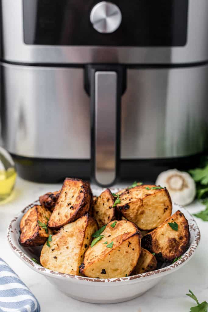  Prep the Potatoes:

Wash and scrub the potatoes to remove any dirt or debris. You can peel them if you prefer, but leaving the skin on adds texture and flavor. Cut the potatoes into evenly-sized pieces, typically around 1-inch cubes.
2. Season the Potatoes:

In a large bowl, combine the potato cubes with olive oil, salt, black pepper, garlic powder, and paprika. Use your hands or a spoon to toss the potatoes, ensuring they are evenly coated with the seasonings. Feel free to add any optional seasonings or herbs at this stage for extra flavor.
3. Preheat the Instant Pot Air Fryer:

Place the Instant Pot Air Fryer Lid on your Instant Pot and preheat it according to the manufacturer's instructions. This usually involves selecting the air fryer function and setting the temperature.
4. Arrange the Potatoes:

Spread the seasoned potato cubes in a single layer in the air fryer basket. Avoid overcrowding, as this can hinder proper crisping. If needed, cook them in batches.
5. Air Fry the Potatoes:

Set the Instant Pot to air fry mode at a temperature of around 380-400°F (190-200°C). Cook the potatoes for about 20-25 minutes, flipping them halfway through to ensure even browning. Cooking times may vary based on your specific appliance and the size of the potato cubes.
6. Check for Doneness:

The roasted potatoes are done when they are crispy and golden brown on the outside, and tender on the inside. Pierce them with a fork or knife to check for doneness.
7. Optional: Garnish and Serve:

Once the potatoes are perfectly roasted, you can garnish them with freshly chopped herbs, grated Parmesan cheese, or a sprinkle of lemon zest for added flavor and presentation.
8. Serve Hot:

Transfer your Instant Pot Air Fryer Roasted Potatoes to a serving dish and enjoy them hot as a side dish, brunch addition, or snack.
These roasted potatoes are versatile and make a