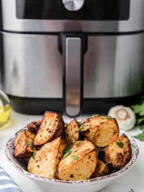 Prep the Potatoes: Wash and scrub the potatoes to remove any dirt or debris. You can peel them if you prefer, but leaving the skin on adds texture and flavor. Cut the potatoes into evenly-sized pieces, typically around 1-inch cubes. 2. Season the Potatoes: In a large bowl, combine the potato cubes with olive oil, salt, black pepper, garlic powder, and paprika. Use your hands or a spoon to toss the potatoes, ensuring they are evenly coated with the seasonings. Feel free to add any optional seasonings or herbs at this stage for extra flavor. 3. Preheat the Instant Pot Air Fryer: Place the Instant Pot Air Fryer Lid on your Instant Pot and preheat it according to the manufacturer's instructions. This usually involves selecting the air fryer function and setting the temperature. 4. Arrange the Potatoes: Spread the seasoned potato cubes in a single layer in the air fryer basket. Avoid overcrowding, as this can hinder proper crisping. If needed, cook them in batches. 5. Air Fry the Potatoes: Set the Instant Pot to air fry mode at a temperature of around 380-400°F (190-200°C). Cook the potatoes for about 20-25 minutes, flipping them halfway through to ensure even browning. Cooking times may vary based on your specific appliance and the size of the potato cubes. 6. Check for Doneness: The roasted potatoes are done when they are crispy and golden brown on the outside, and tender on the inside. Pierce them with a fork or knife to check for doneness. 7. Optional: Garnish and Serve: Once the potatoes are perfectly roasted, you can garnish them with freshly chopped herbs, grated Parmesan cheese, or a sprinkle of lemon zest for added flavor and presentation. 8. Serve Hot: Transfer your Instant Pot Air Fryer Roasted Potatoes to a serving dish and enjoy them hot as a side dish, brunch addition, or snack. These roasted potatoes are versatile and make a
