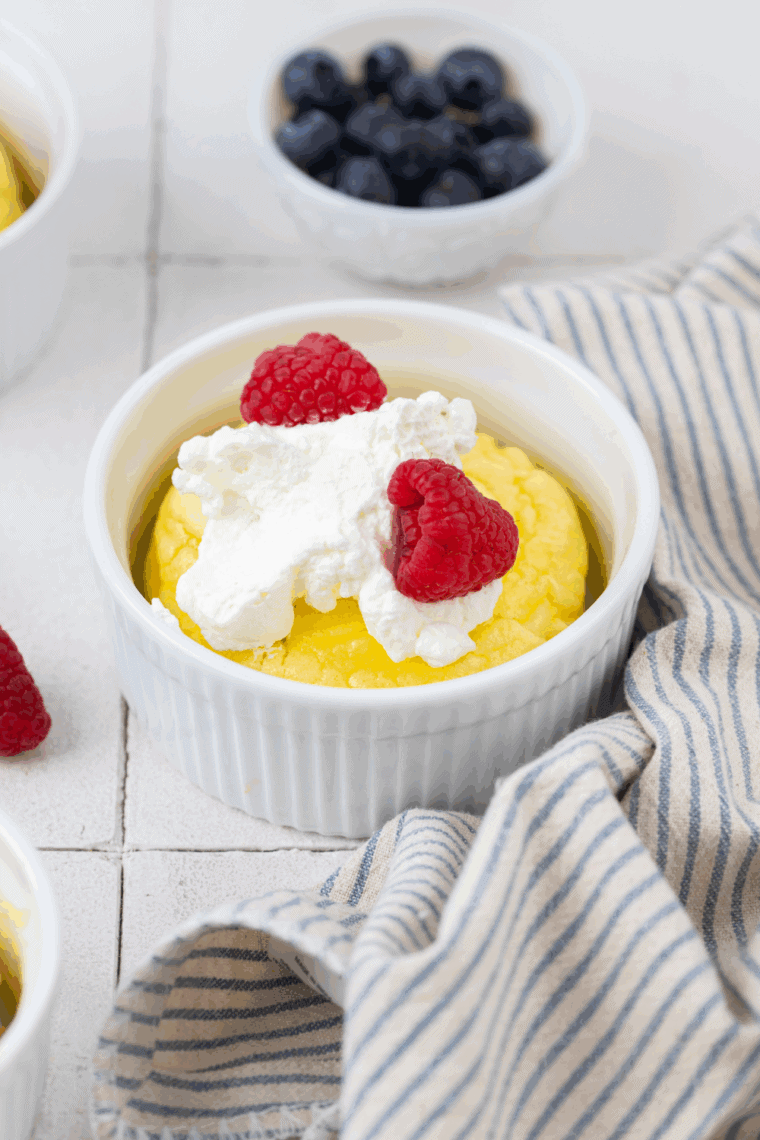 Golden, fluffy air fryer soufflé pancakes served with whipped cream, maple syrup, and fresh berries.