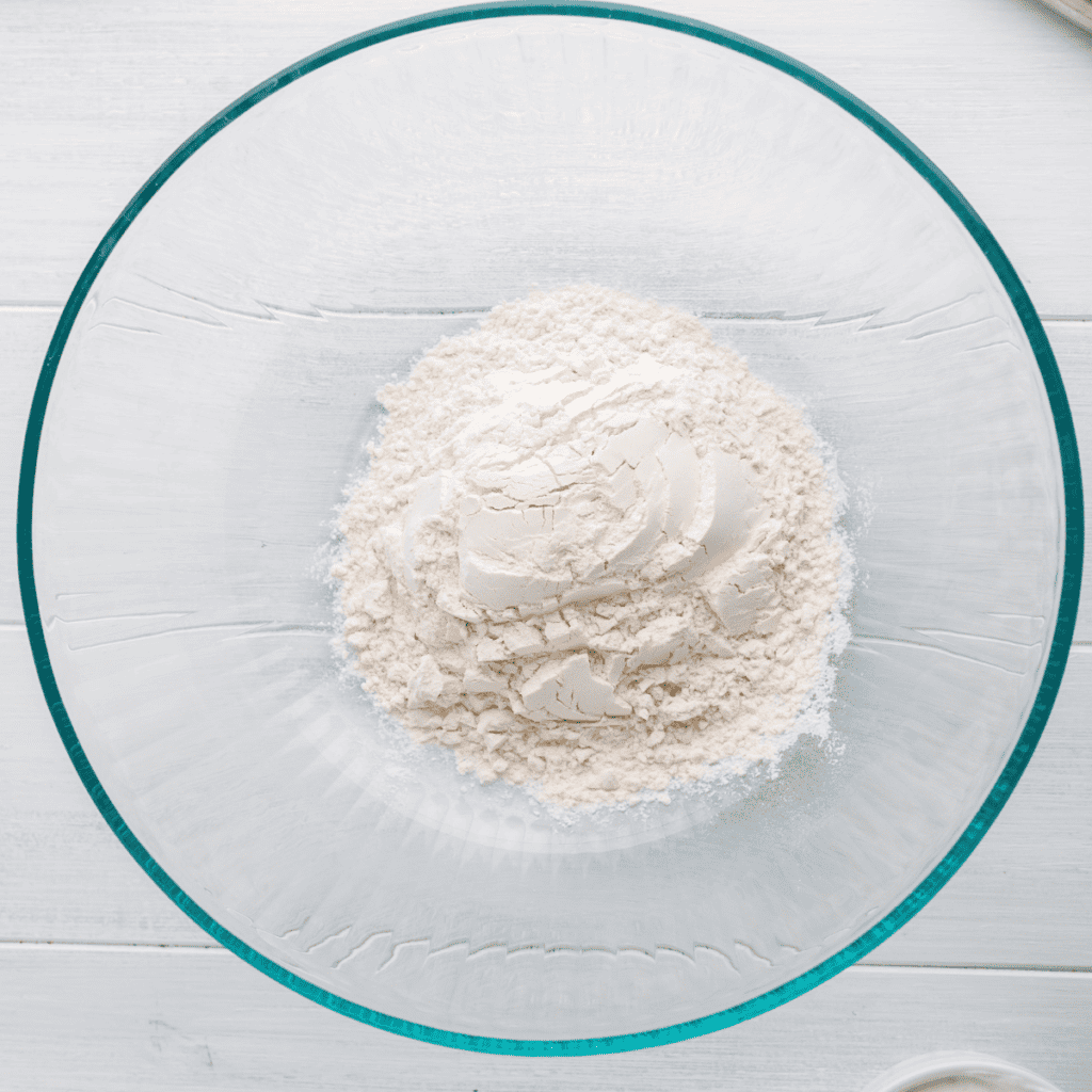 Mixing Greek yogurt and self-rising flour together to form a dough for bagel bites