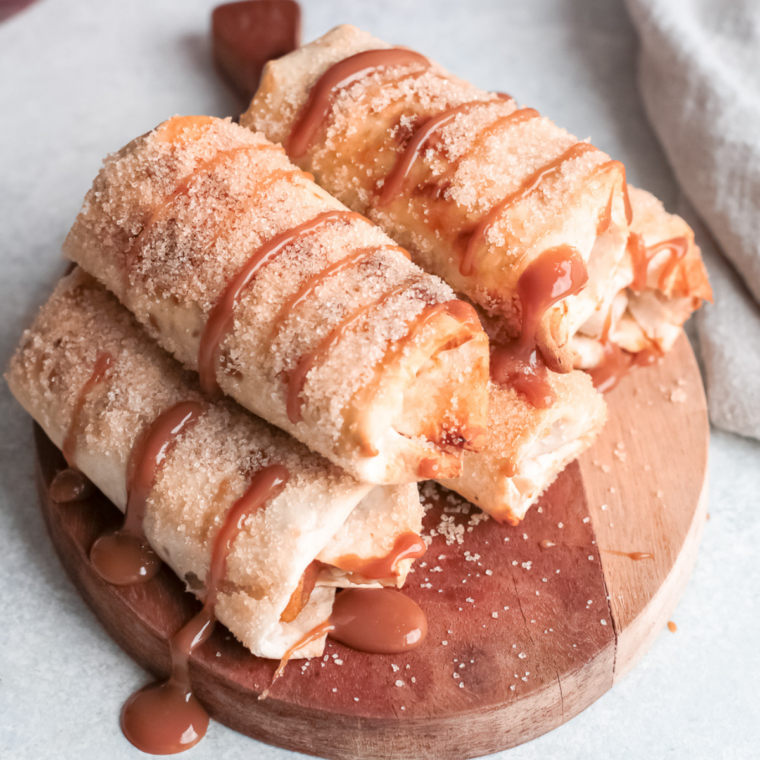 Apple flautas cut open showing warm cinnamon apple filling inside