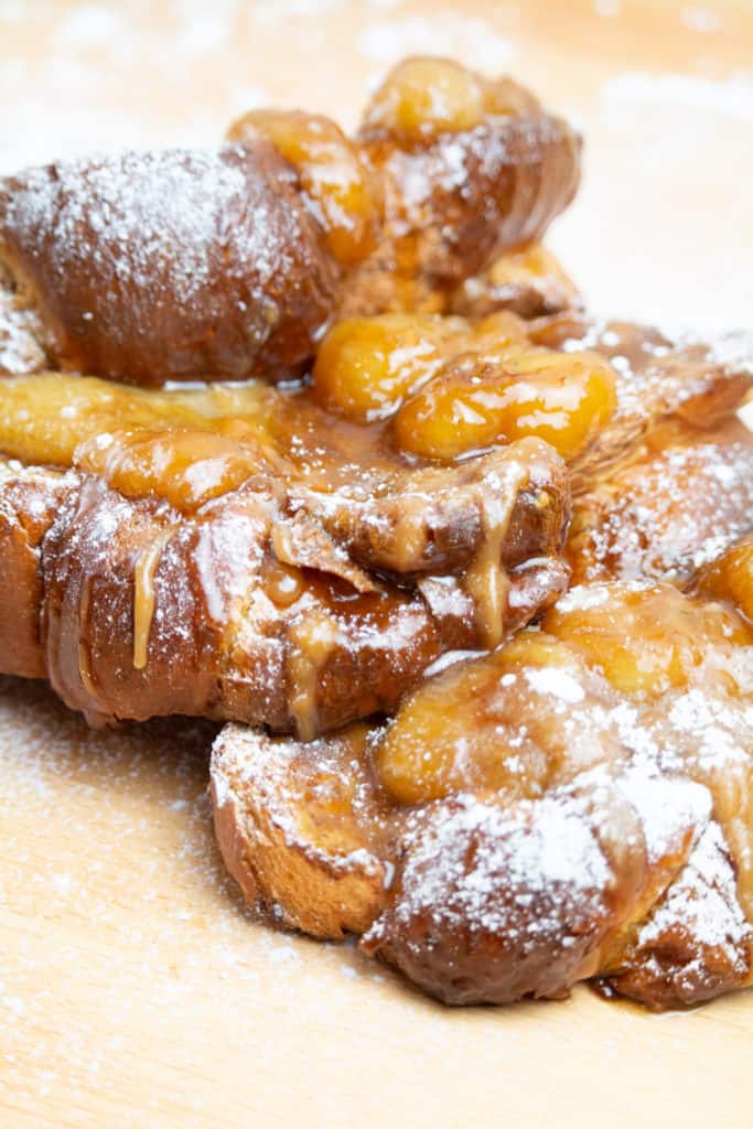 "Delicious Air Fryer Bananas Foster French Toast served on a plate with a side of fresh fruit."