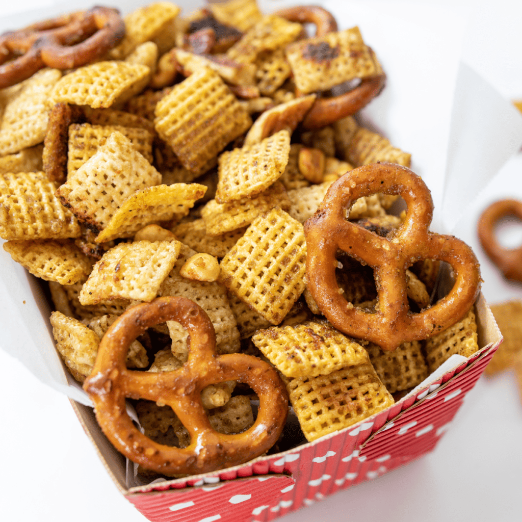 Close-up of crunchy griddle Chex mix with pretzels, peanuts, and toasted cereal