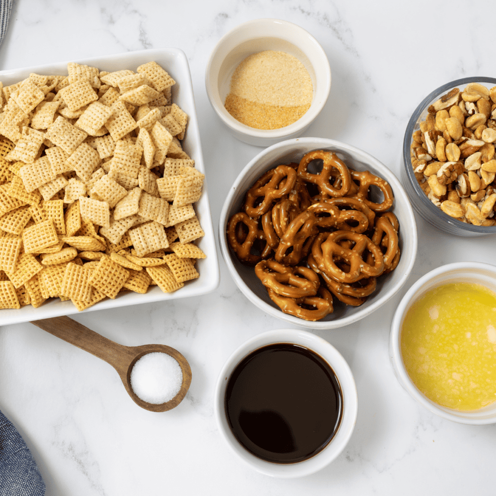 Ingredients for Blackstone Chex Party Mix laid out on a kitchen counter