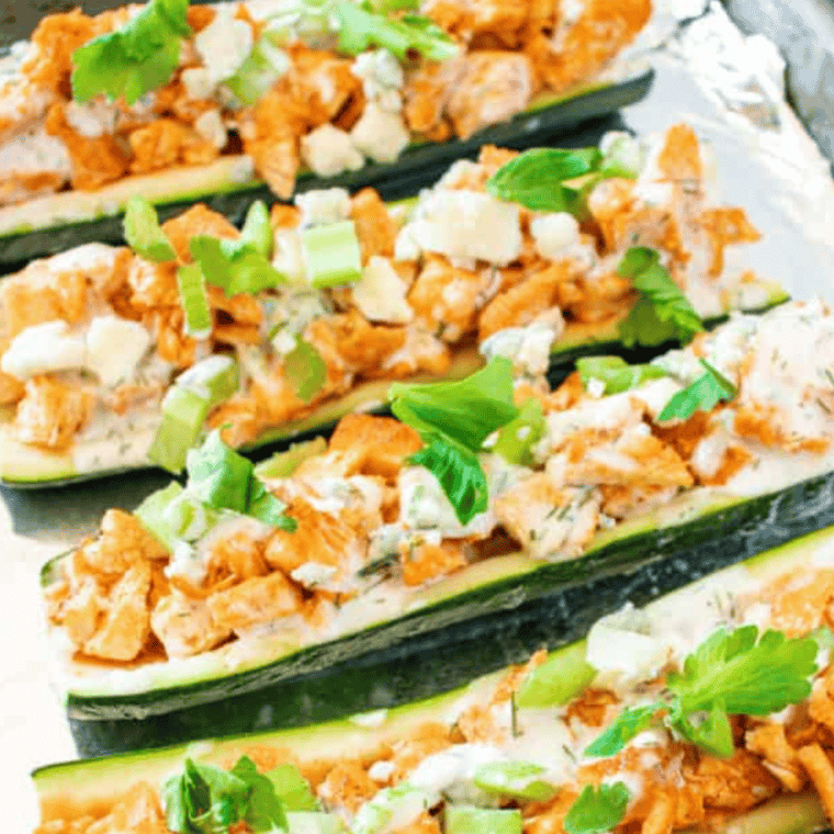 Sprinkling shredded cheese on top of filled zucchini boats before baking.