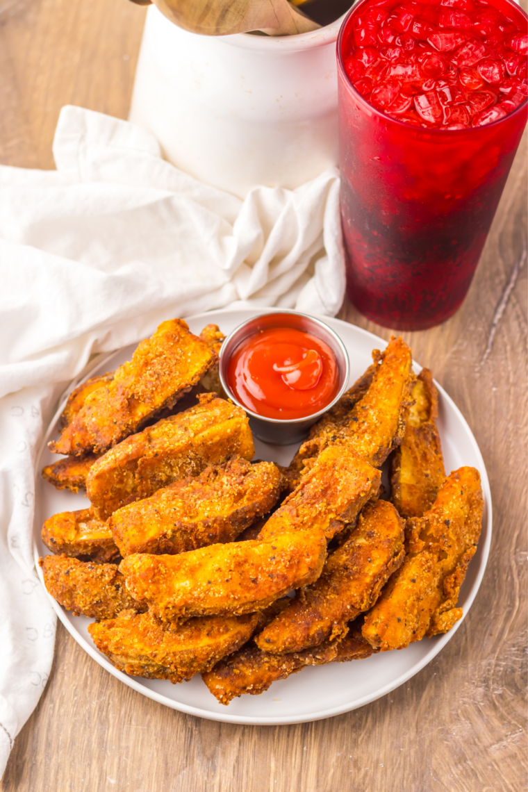Crispy copycat Buffalo Wild Wings potato wedges on a plate with ranch dressing for dipping